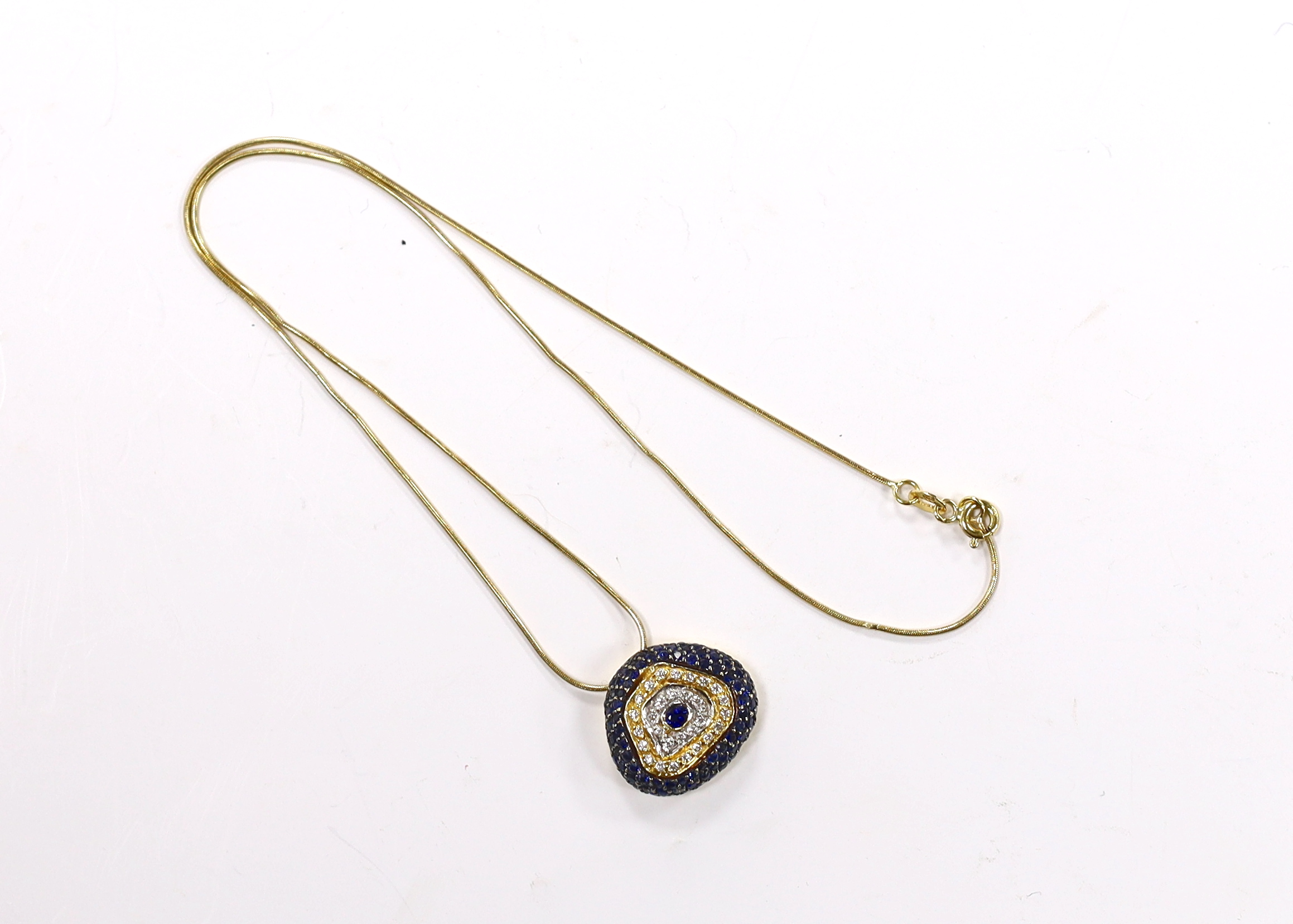 A modern 750 yellow metal, sapphire and diamond cluster set pendant necklace, overall 44cm, gross weight 9.3 grams.